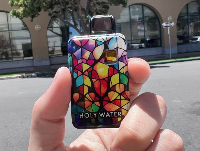 hand holding best vape cart winner Holy Water