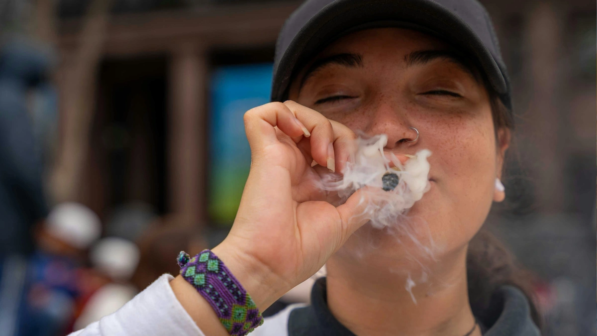 person smoking cannabis joint